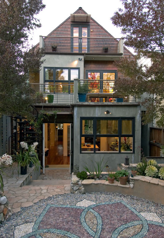 This is an example of a mid-sized eclectic three-storey concrete exterior in San Francisco with a gable roof.