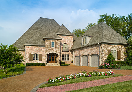 This is an example of a large traditional three-storey brick red exterior in Nashville with a gable roof.