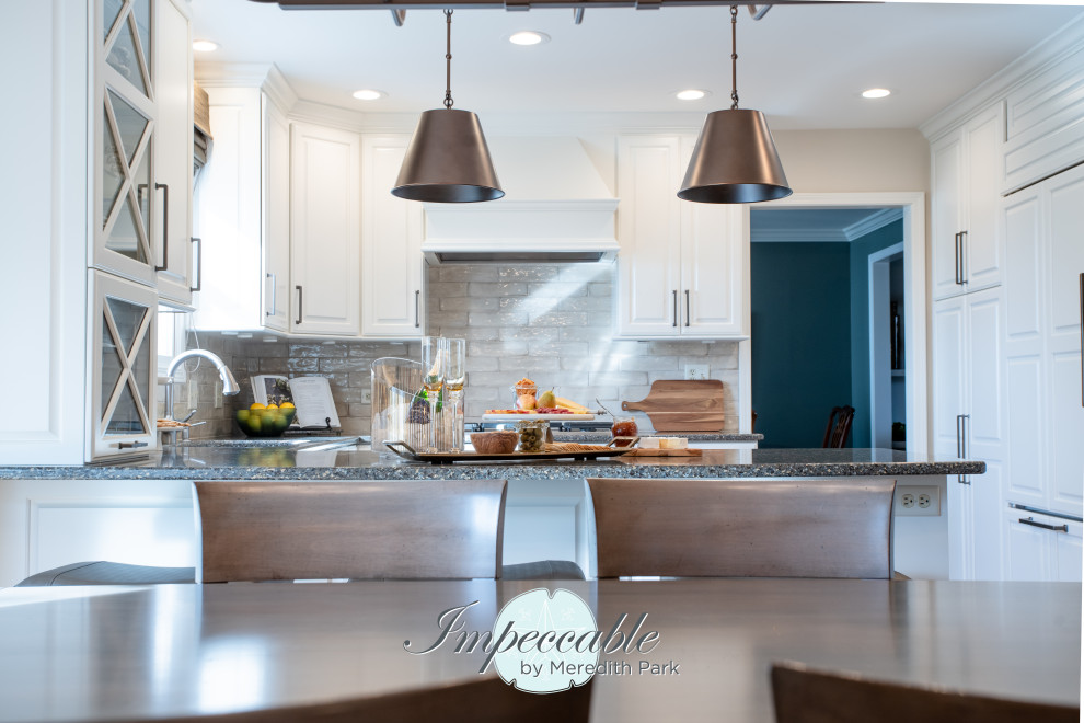 Eat-in kitchen - large transitional u-shaped medium tone wood floor and brown floor eat-in kitchen idea in Chicago with an undermount sink, raised-panel cabinets, white cabinets, quartz countertops, beige backsplash, subway tile backsplash, paneled appliances, a peninsula and multicolored countertops