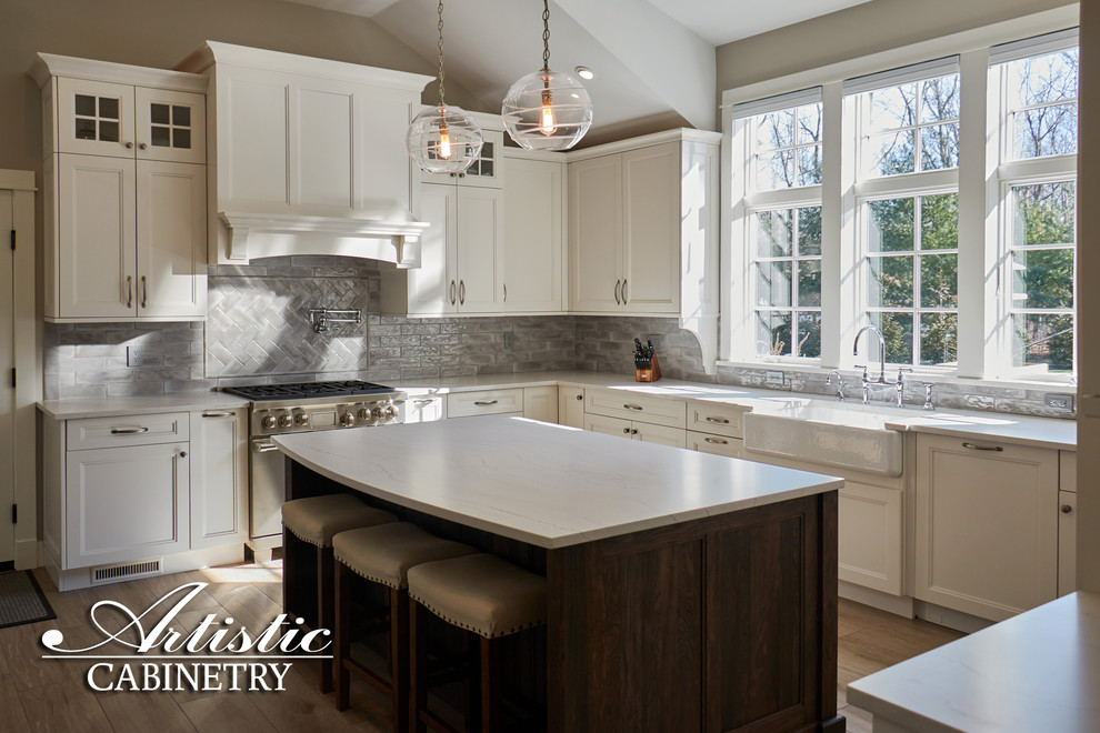 Inspiration for a mid-sized transitional u-shaped porcelain tile and beige floor open concept kitchen remodel in New York with a farmhouse sink, shaker cabinets, white cabinets, quartzite countertops, gray backsplash, porcelain backsplash, stainless steel appliances, an island and gray countertops