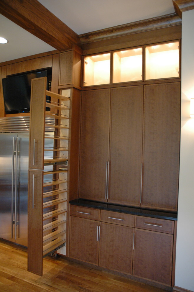 Transitional u-shaped eat-in kitchen photo with an undermount sink, flat-panel cabinets, laminate countertops, white backsplash and stainless steel appliances