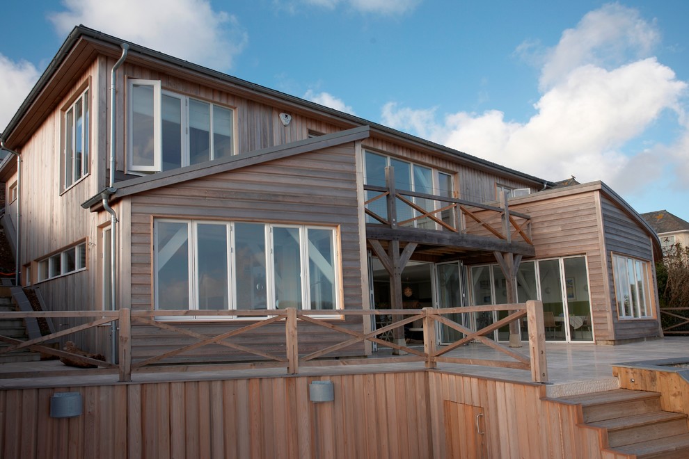 Large beach style exterior in Devon with wood siding.