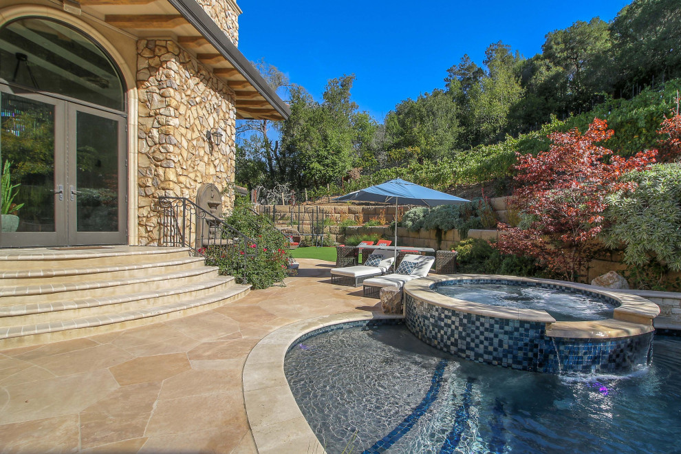 Inspiration for a large mediterranean back patio in San Francisco with natural stone paving.