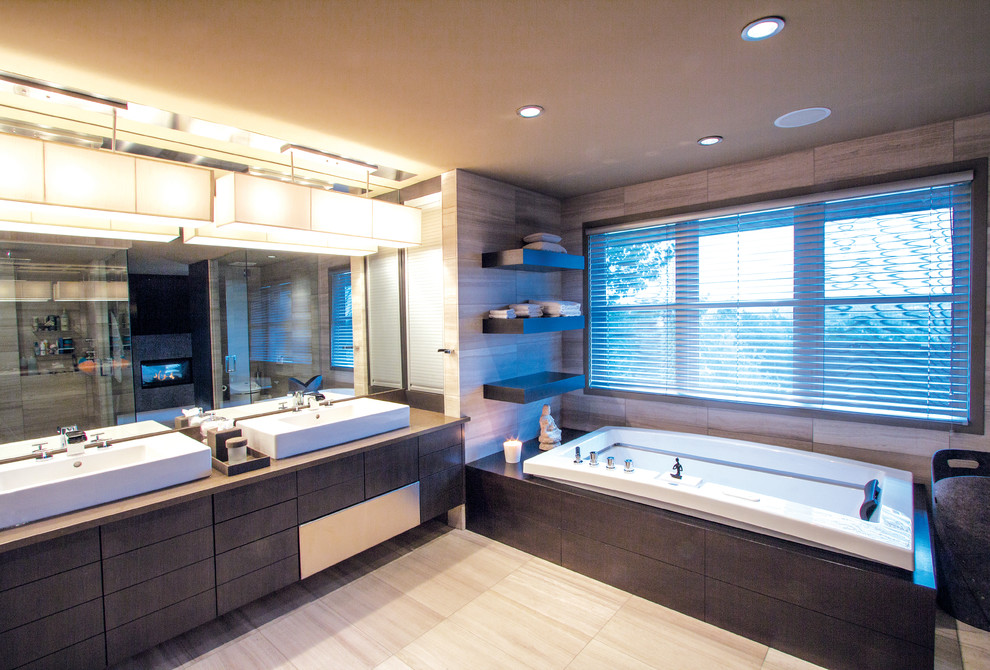 Large contemporary bathroom in Calgary with a vessel sink, flat-panel cabinets, dark wood cabinets, engineered quartz benchtops, a one-piece toilet, gray tile, porcelain tile, grey walls and ceramic floors.