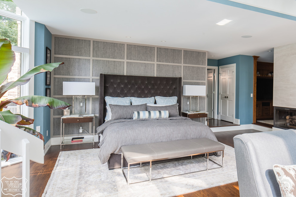 Bedroom - huge transitional master medium tone wood floor and brown floor bedroom idea with blue walls, a two-sided fireplace and a tile fireplace
