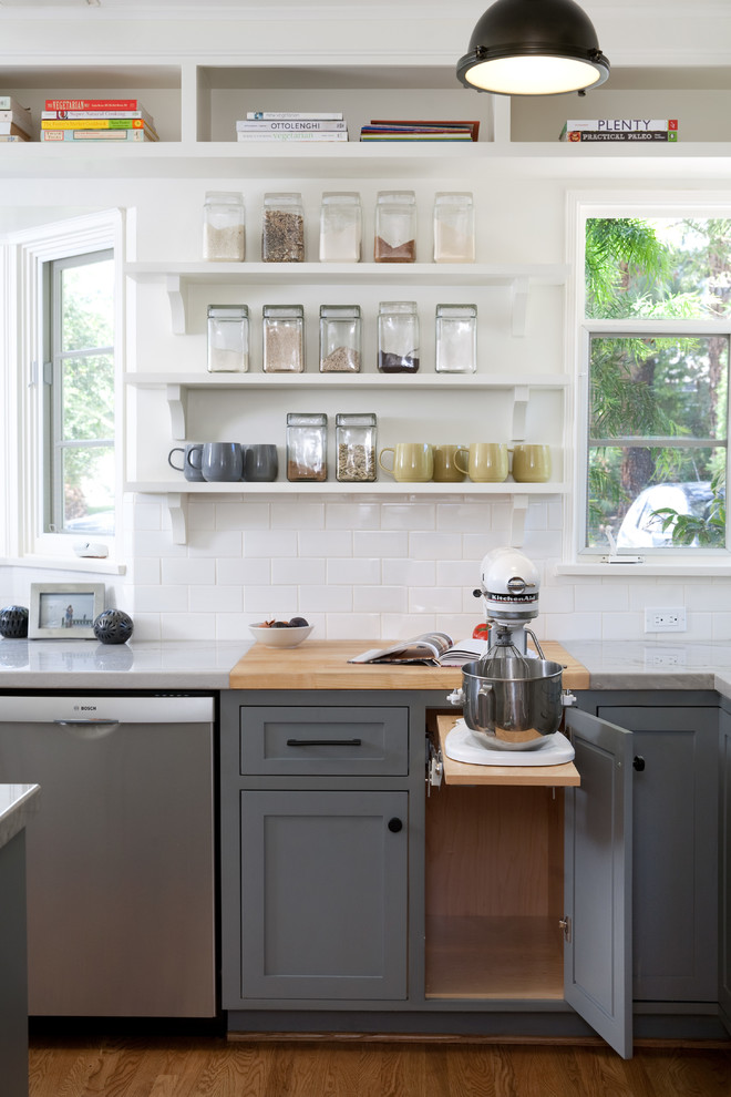 Inspiration for a large transitional medium tone wood floor kitchen remodel in Santa Barbara with shaker cabinets, gray cabinets, white backsplash, subway tile backsplash and stainless steel appliances
