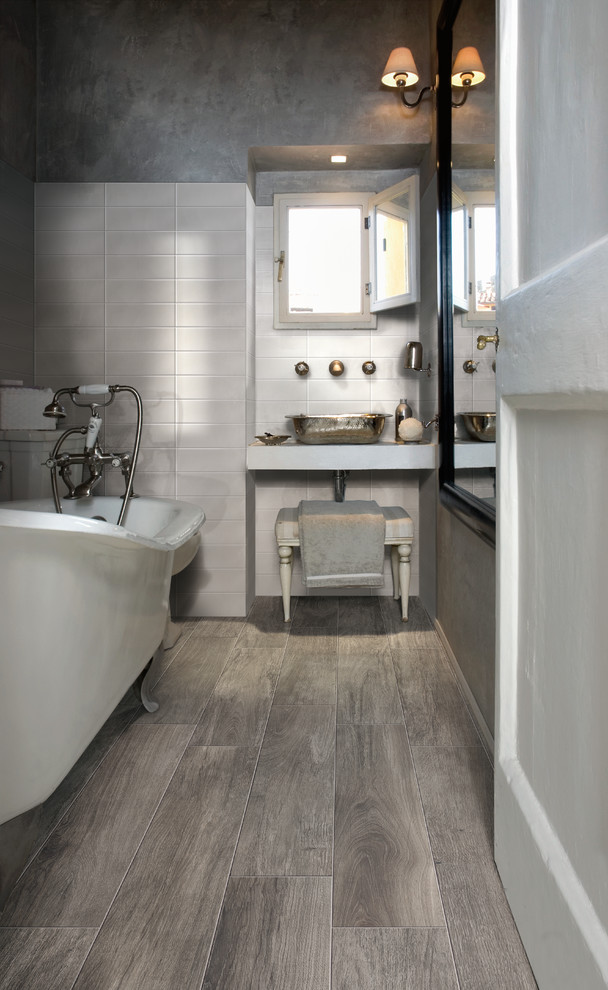 Photo of a mid-sized contemporary bathroom in Orange County with a vessel sink, engineered quartz benchtops, a claw-foot tub, gray tile, ceramic tile, grey walls, porcelain floors and white cabinets.