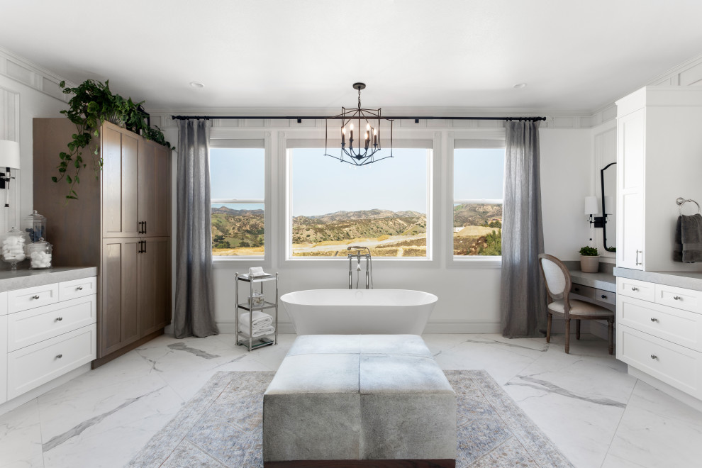 Large classic ensuite bathroom in Los Angeles with shaker cabinets, white cabinets, a freestanding bath, a bidet, white tiles, porcelain tiles, white walls, porcelain flooring, a submerged sink, engineered stone worktops, white floors, grey worktops, double sinks and a built in vanity unit.
