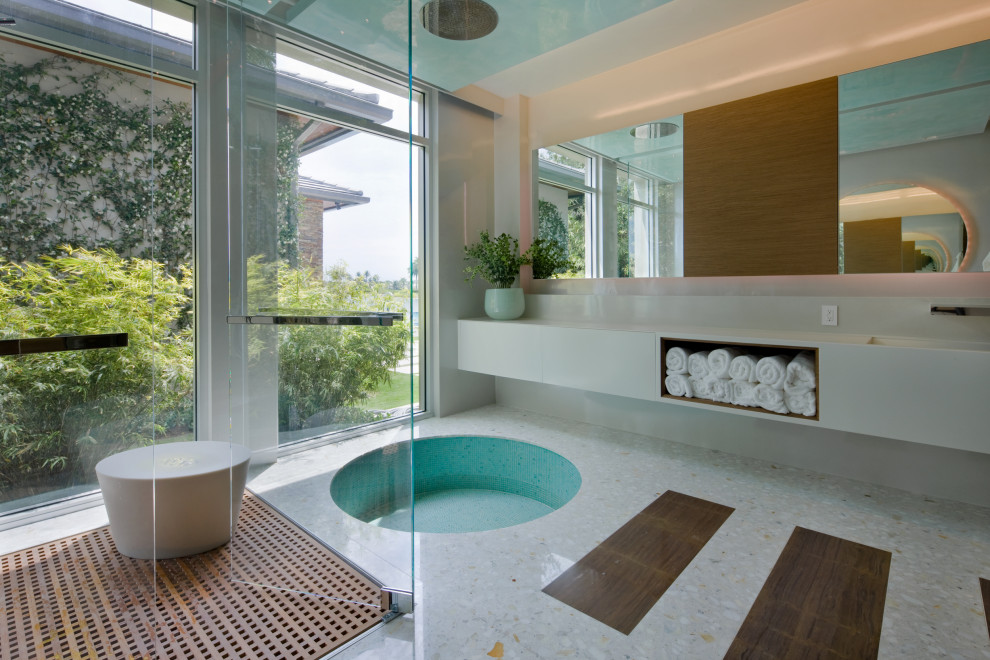 Large contemporary master bathroom with flat-panel cabinets, grey cabinets, an open shower, marble benchtops, multi-coloured floor, a hinged shower door, a japanese tub, white walls, marble floors and white benchtops.