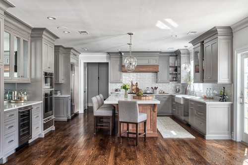 Transitional grey kitchen featuring shaker-style premade kitchen cabinet doors and bright tile backsplash