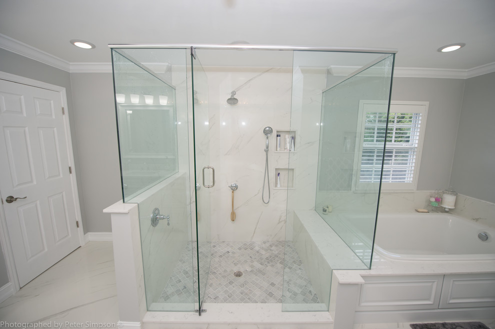 Large transitional master bathroom in Miami with furniture-like cabinets, white cabinets, a drop-in tub, a double shower, a two-piece toilet, white tile, marble, grey walls, marble floors, an undermount sink, marble benchtops, white floor and a hinged shower door.