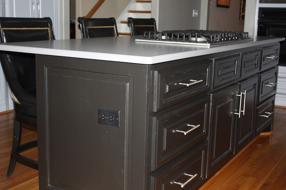 Example of a large transitional u-shaped light wood floor eat-in kitchen design with a double-bowl sink, raised-panel cabinets, gray cabinets, quartz countertops, beige backsplash, ceramic backsplash, stainless steel appliances and an island