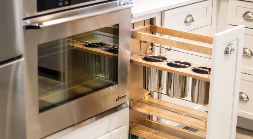 Inspiration for a small transitional l-shaped porcelain tile and gray floor eat-in kitchen remodel in Boise with a single-bowl sink, shaker cabinets, white cabinets, quartz countertops, blue backsplash, glass tile backsplash, stainless steel appliances and an island