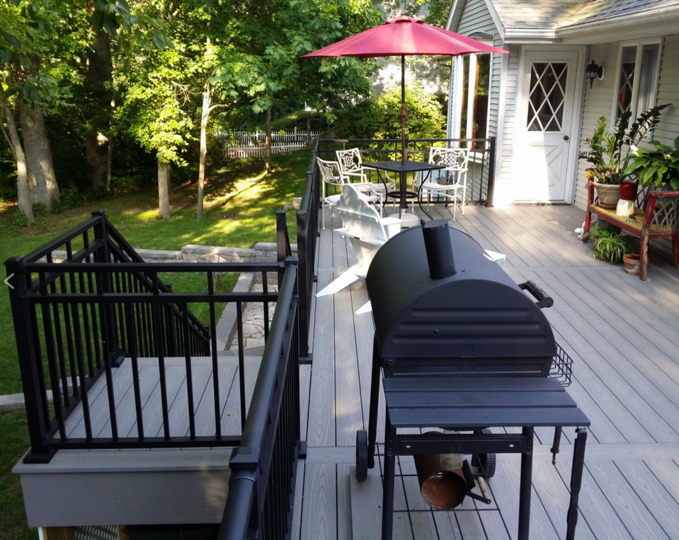 Example of a large backyard balcony deck design with no cover