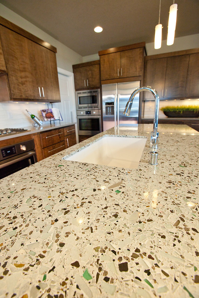 Transitional eat-in kitchen photo in Seattle with flat-panel cabinets and an island
