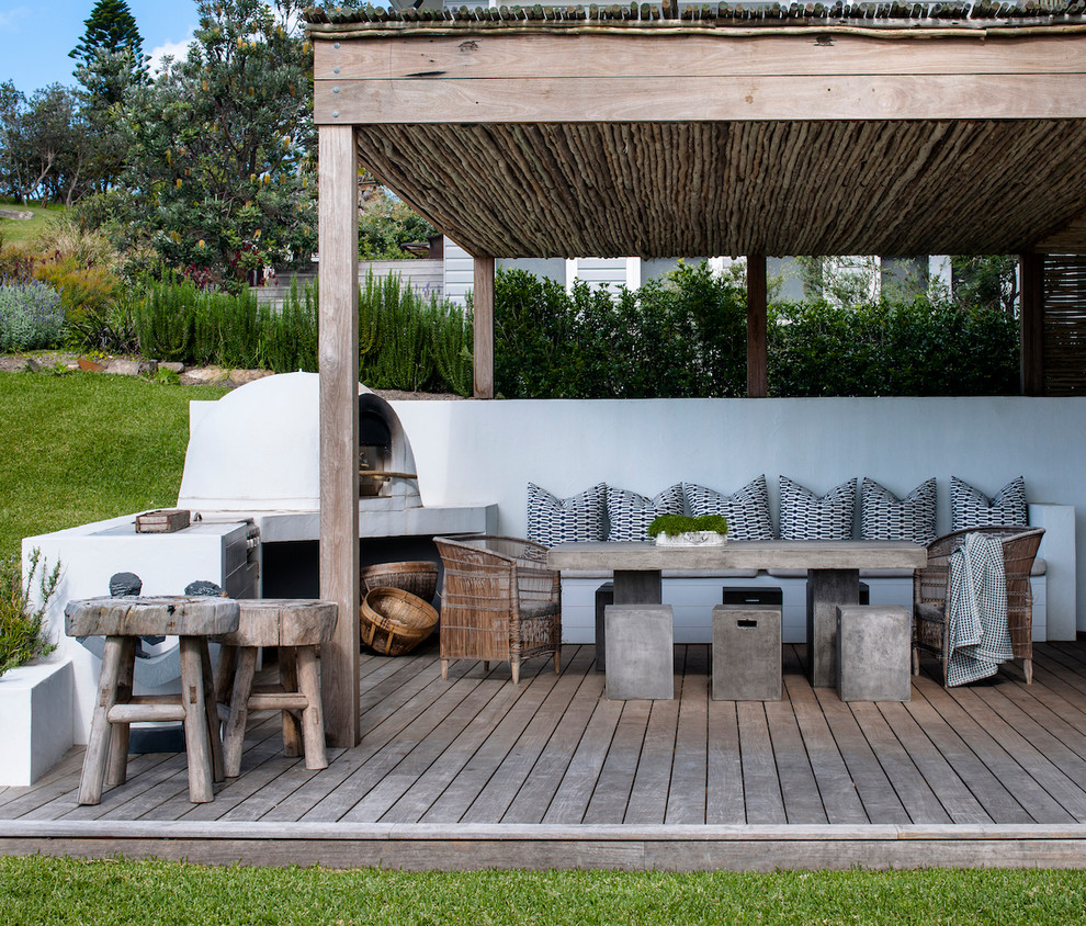 Inspiration for a beach style backyard deck in Sydney with an outdoor kitchen and a pergola.