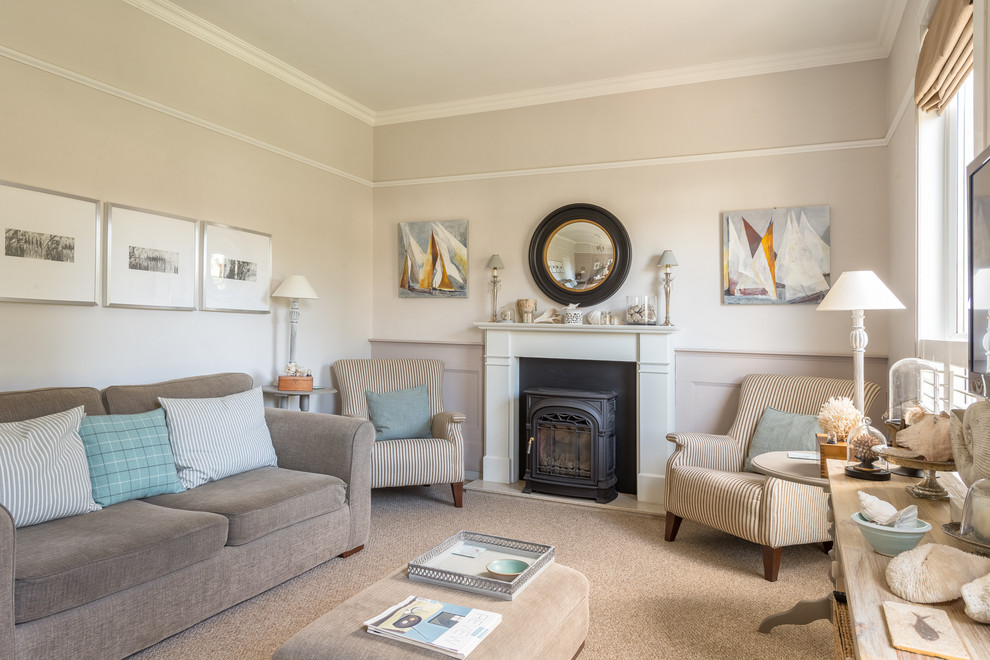 This is an example of a mid-sized contemporary formal enclosed living room in Devon with beige walls, carpet, a two-sided fireplace, a plaster fireplace surround and a wall-mounted tv.