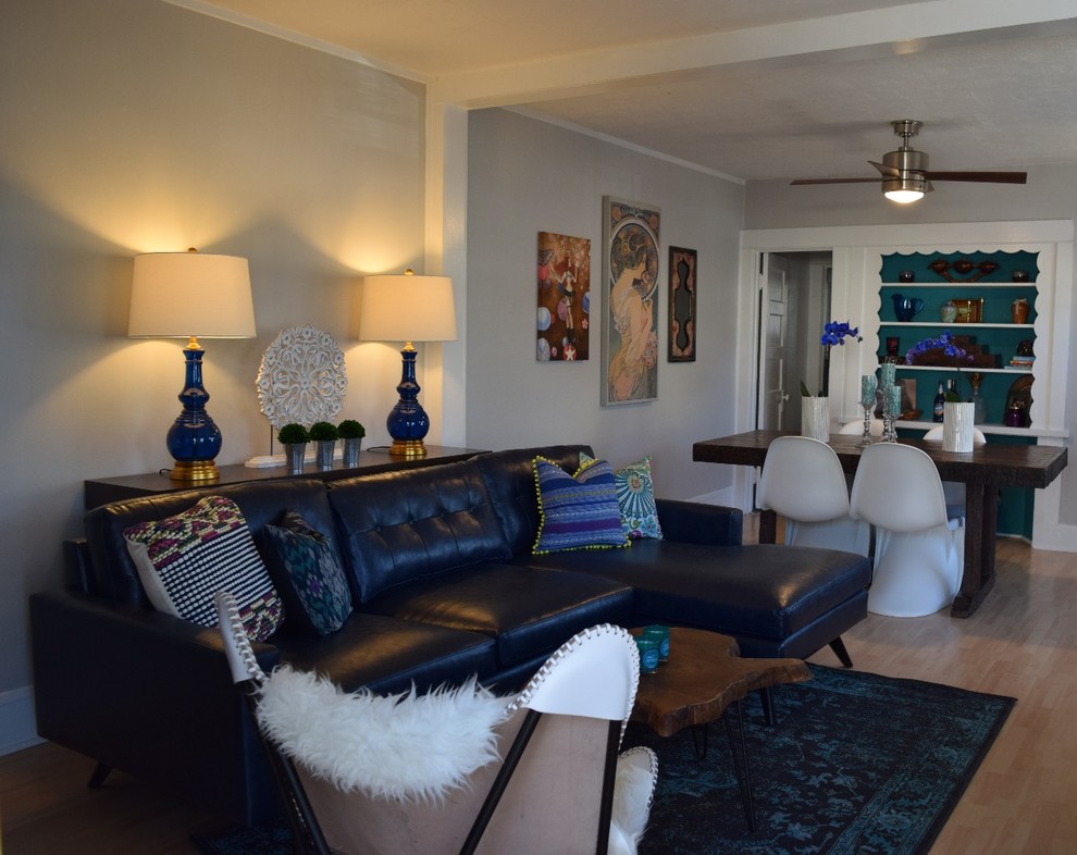 Inspiration for a small eclectic open concept light wood floor living room remodel in Orange County with gray walls, no fireplace and a tv stand