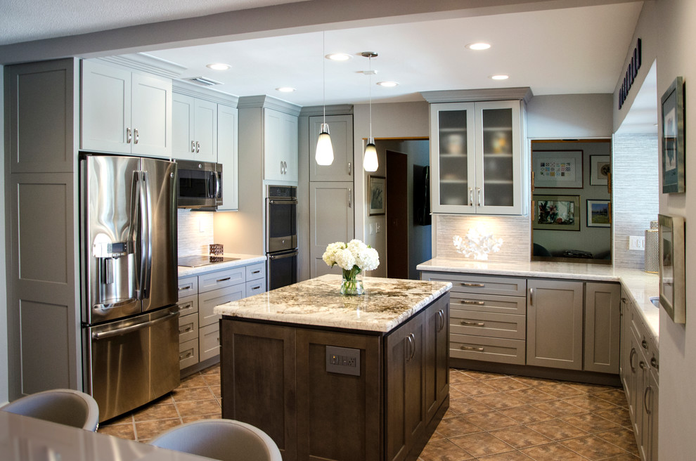 Example of a mid-sized transitional u-shaped open concept kitchen design in Miami with an undermount sink, shaker cabinets, gray cabinets, quartzite countertops, gray backsplash, porcelain backsplash, stainless steel appliances and an island