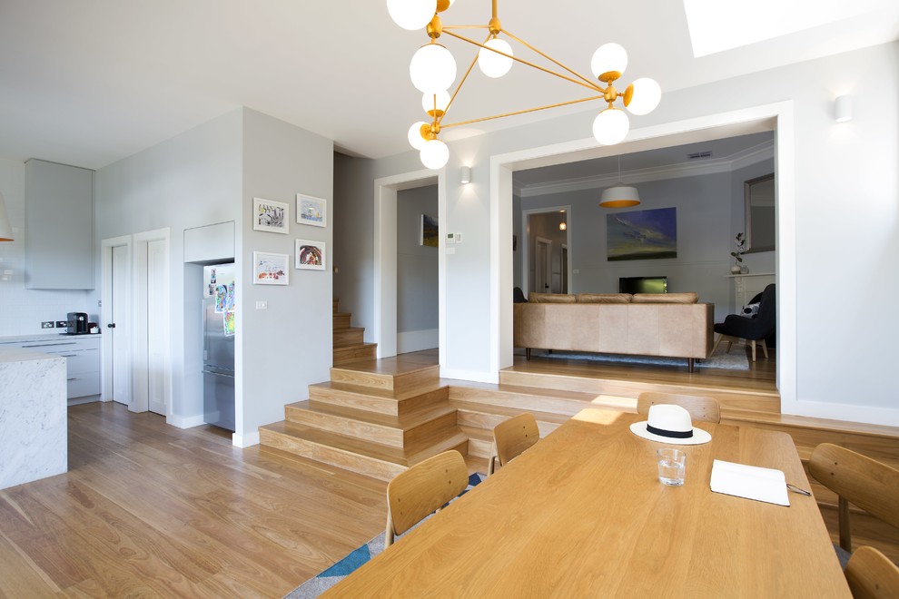This is an example of a contemporary dining room in Sydney.