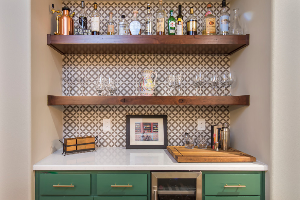 Inspiration for a transitional l-shaped home bar in Los Angeles with shaker cabinets, green cabinets, quartz benchtops, multi-coloured splashback, porcelain splashback, brown floor and white benchtop.