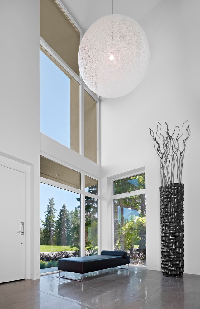 Inspiration for a modern foyer in Edmonton with white walls.