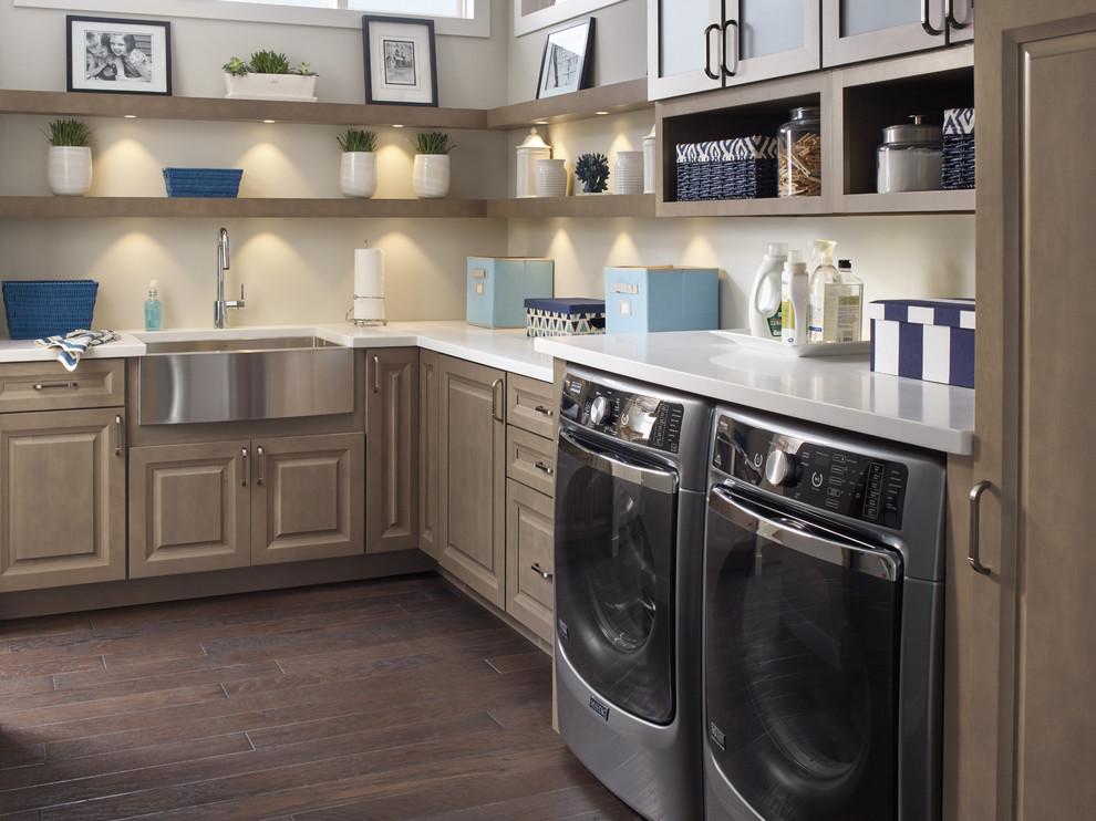 Design ideas for a large beach style l-shaped dedicated laundry room in Chicago with a farmhouse sink, raised-panel cabinets, beige walls, a side-by-side washer and dryer, quartz benchtops, dark hardwood floors, brown floor and medium wood cabinets.