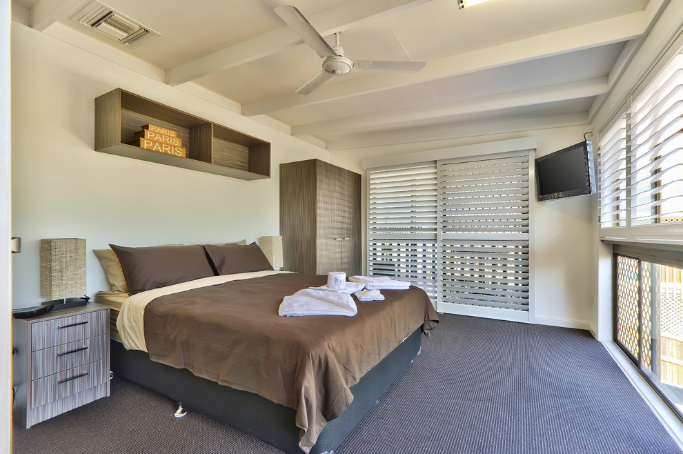 Mid-sized modern guest bedroom in Adelaide with beige walls and carpet.