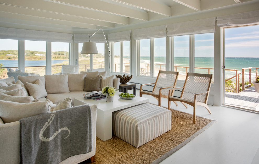 This is an example of a large beach style formal open concept living room in Boston with beige walls, concrete floors, no tv and grey floor.