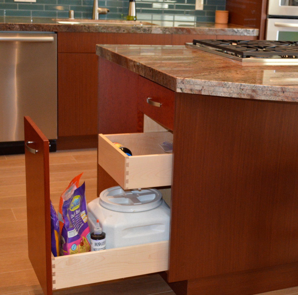 Mid-sized trendy galley porcelain tile eat-in kitchen photo in San Diego with a drop-in sink, flat-panel cabinets, light wood cabinets, granite countertops, glass tile backsplash, stainless steel appliances and an island