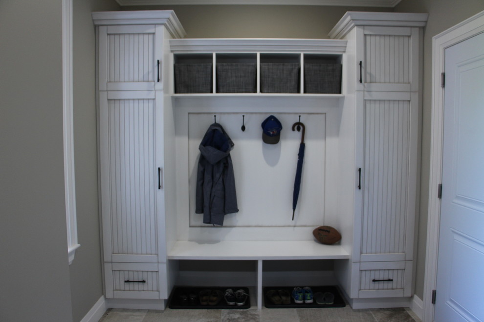 Mudroom - mid-sized transitional porcelain tile and beige floor mudroom idea in Toronto with beige walls and a white front door