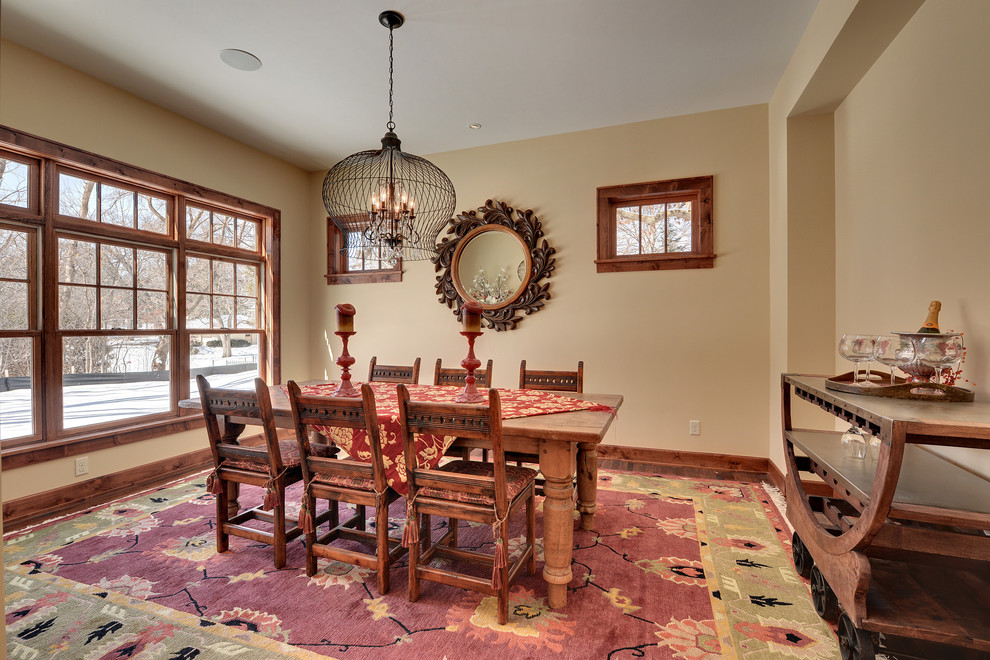 Inspiration for a country dining room in Minneapolis with beige walls and dark hardwood floors.