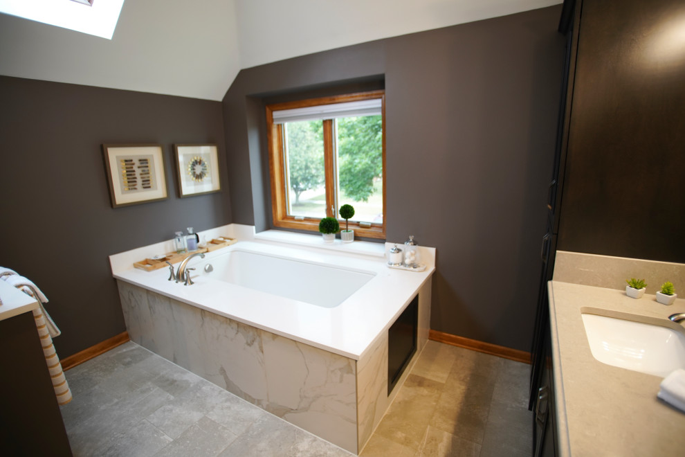 Inspiration for a huge modern master porcelain tile, beige floor, double-sink and vaulted ceiling bathroom remodel in Chicago with brown cabinets, brown walls, an undermount sink, marble countertops, a hinged shower door, beige countertops and a built-in vanity