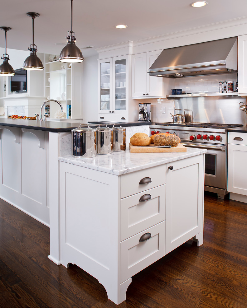 Eat-in kitchen - coastal l-shaped eat-in kitchen idea in Other with a farmhouse sink, recessed-panel cabinets, white cabinets, marble countertops, white backsplash, subway tile backsplash and stainless steel appliances