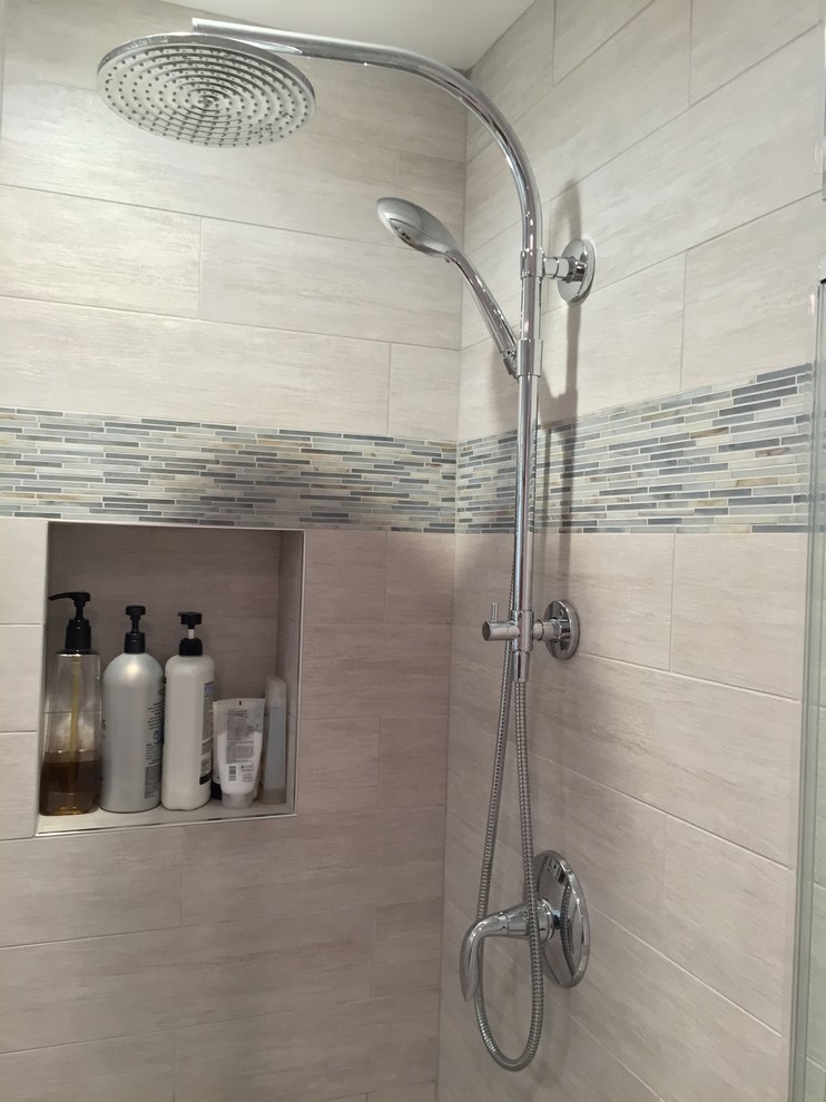 Example of a mid-sized transitional master gray tile and porcelain tile porcelain tile freestanding bathtub design in DC Metro with an undermount sink, shaker cabinets, medium tone wood cabinets, quartz countertops and gray walls