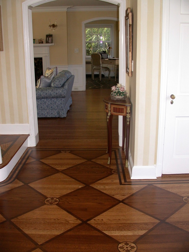 Inspiration for a large transitional foyer in New York with medium hardwood floors and a single front door.