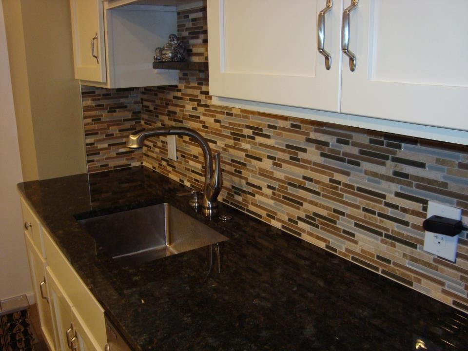 Kitchen - transitional kitchen idea with a double-bowl sink, white cabinets, multicolored backsplash, matchstick tile backsplash, stainless steel appliances and no island