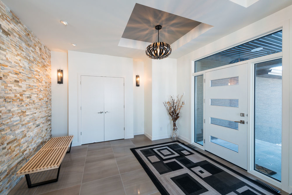 Inspiration for a mid-sized transitional porcelain tile and brown floor vestibule remodel with white walls and a white front door