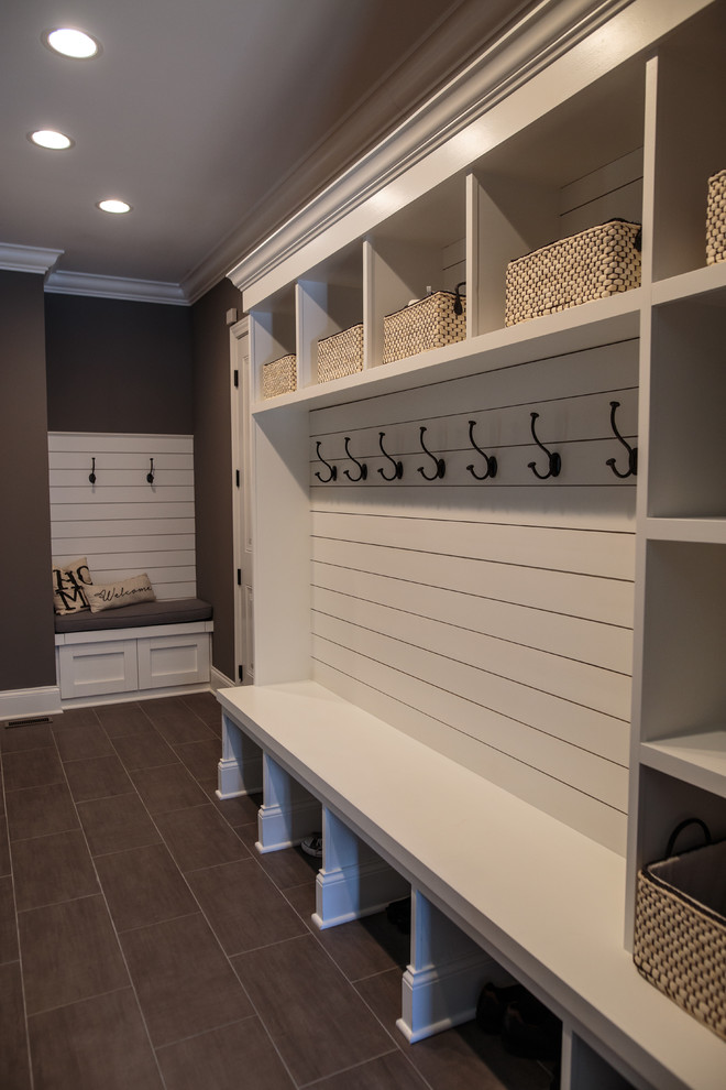 Inspiration for a large transitional mudroom in Chicago with grey walls, porcelain floors, a single front door and a dark wood front door.