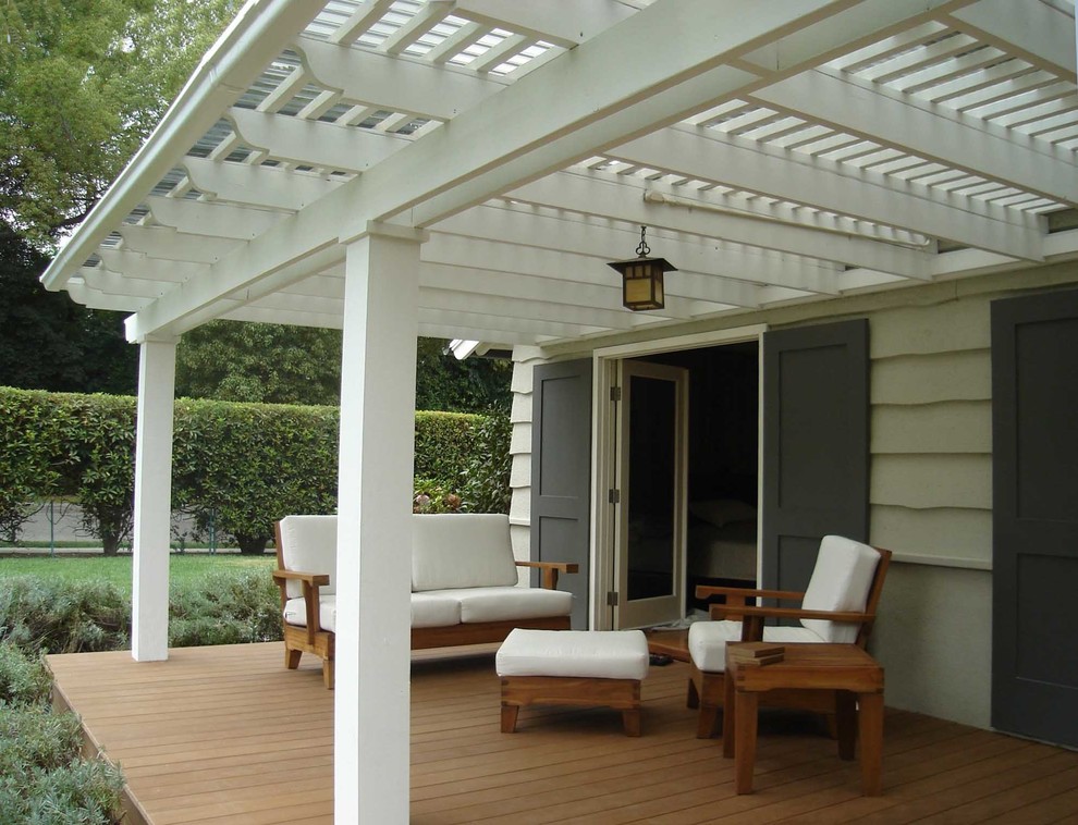 This is an example of a large traditional backyard patio in Los Angeles with decking and a pergola.