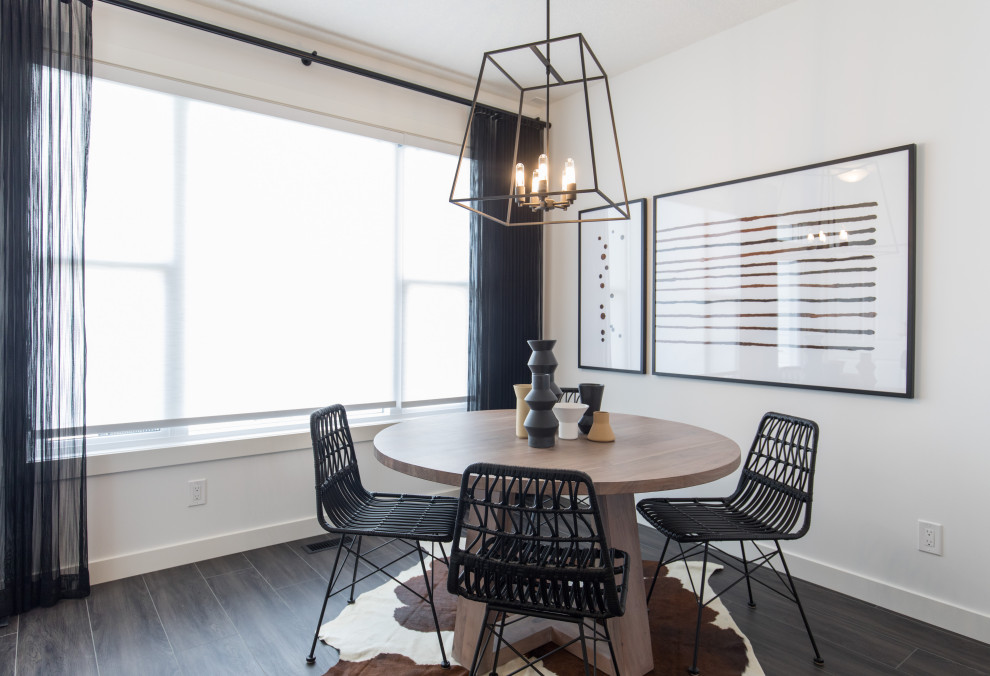 Design ideas for a small scandinavian dining room in Calgary with dark hardwood floors and black floor.