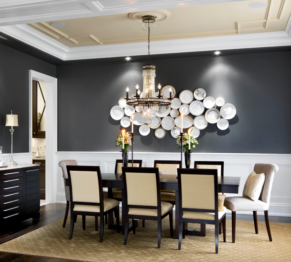 This is an example of a traditional separate dining room in Toronto with black walls and dark hardwood floors.