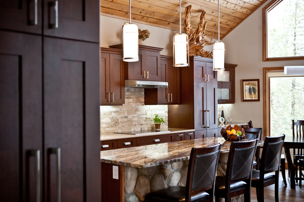 Eat-in kitchen - large rustic l-shaped light wood floor and beige floor eat-in kitchen idea in Toronto with an undermount sink, shaker cabinets, dark wood cabinets, granite countertops, beige backsplash, stone tile backsplash, stainless steel appliances and an island