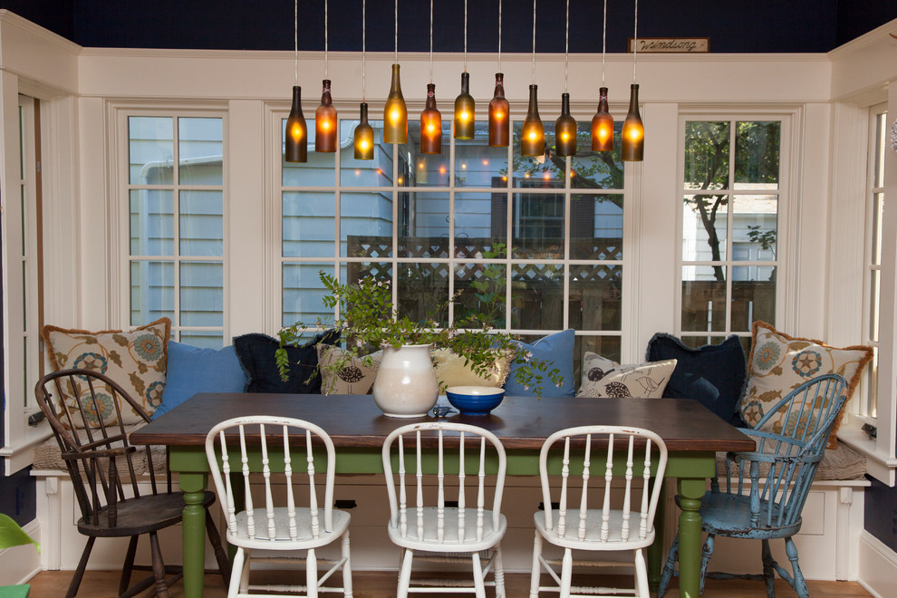 Inspiration for an eclectic dining room in Portland with white walls and dark hardwood floors.