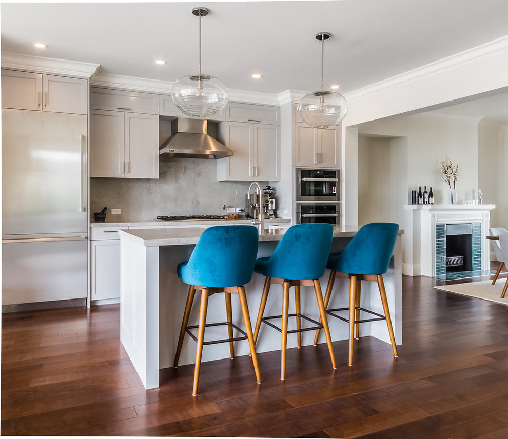 Inspiration for a transitional kitchen in San Francisco with shaker cabinets, white cabinets, grey splashback, stainless steel appliances, dark hardwood floors, with island and brown floor.