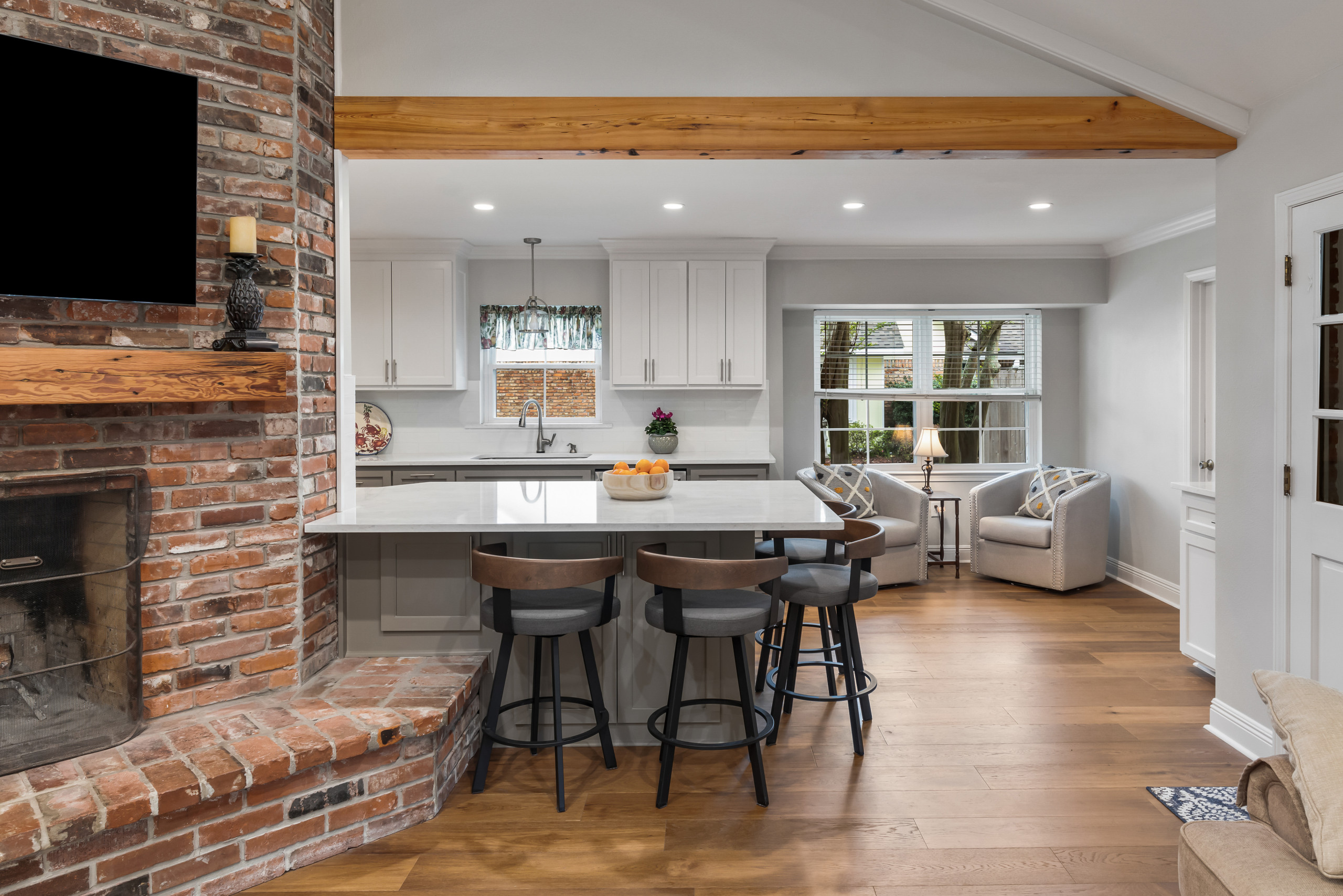 Inspiration for a mid-sized timeless galley medium tone wood floor and brown floor eat-in kitchen remodel in New Orleans with an undermount sink, recessed-panel cabinets, gray cabinets, quartzite coun