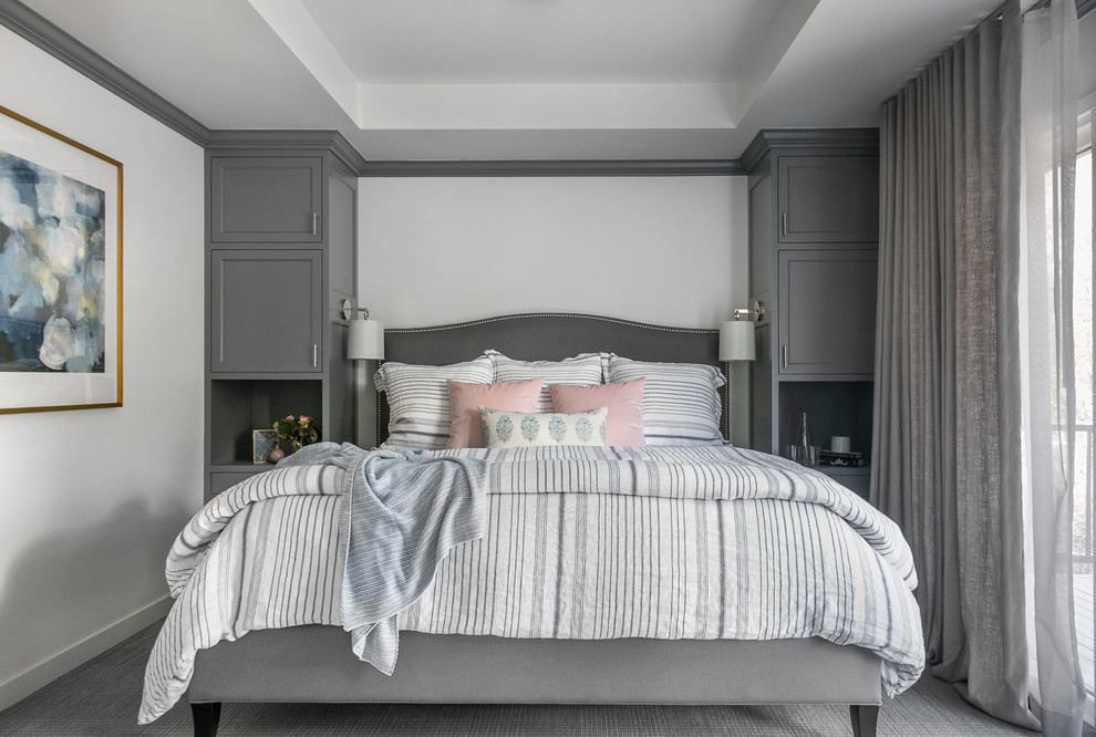 Photo of a transitional bedroom in San Francisco with white walls, carpet and grey floor.