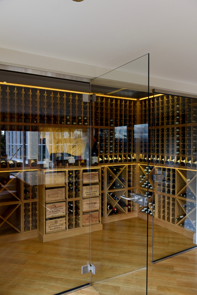 Design ideas for a large contemporary wine cellar in Other with storage racks, light hardwood floors and brown floor.