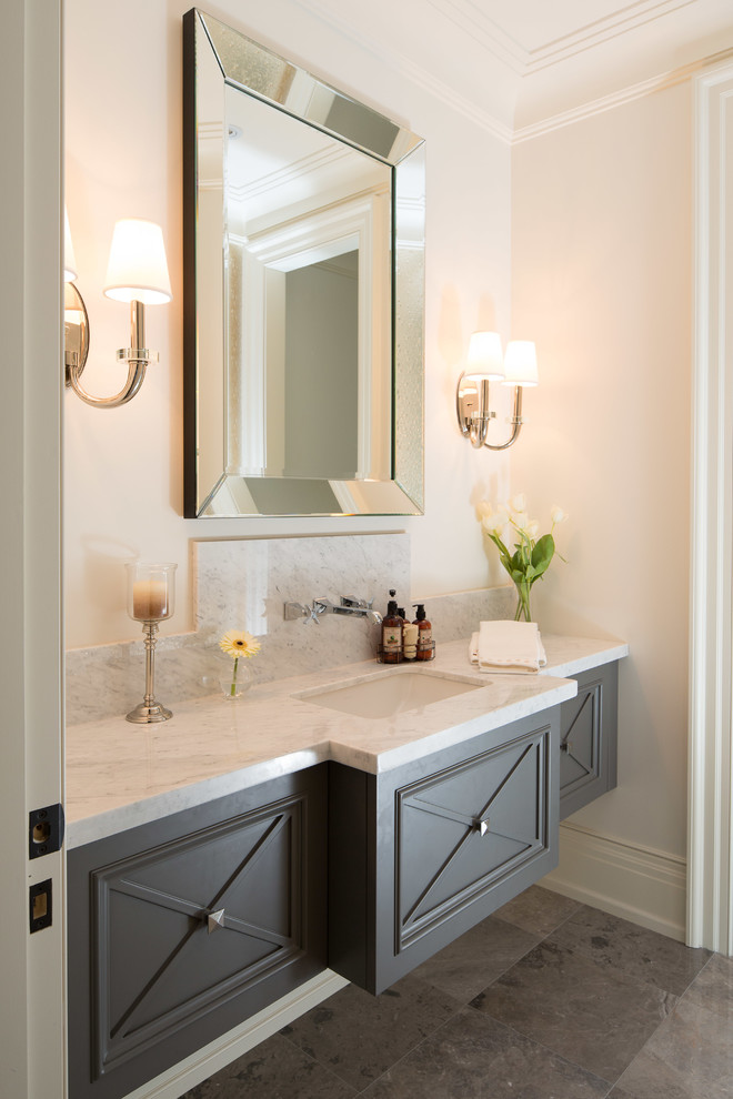 Photo of a large traditional powder room in Toronto with an undermount sink, grey cabinets, marble benchtops, white walls, marble floors and white benchtops.