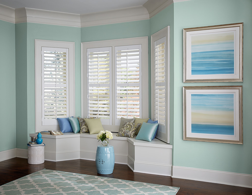 Inspiration for a beach style family room in Orange County with blue walls, dark hardwood floors and no fireplace.